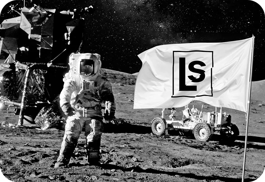 An astronaut on the moon with a Lead Science flag