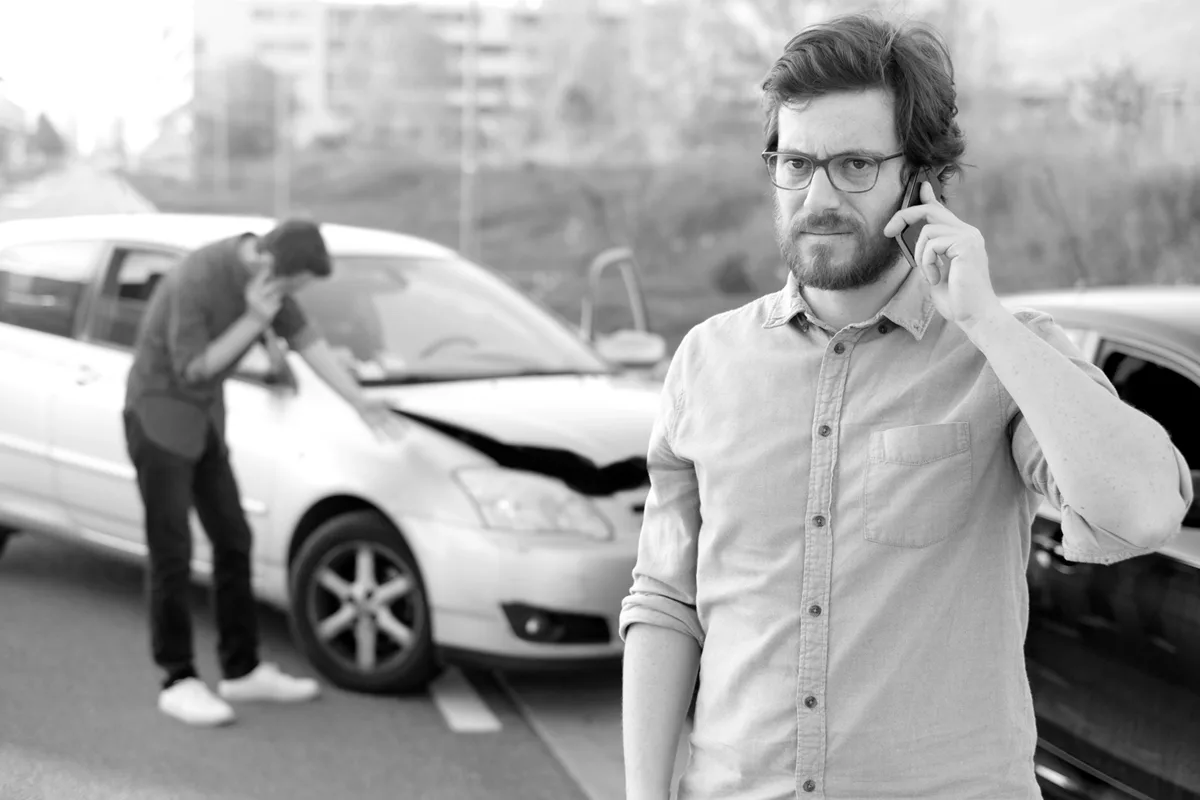 Why Your Law Firm Needs Lead Generation, man standing in front of car accident, shows need for attorneys to capture this type of client's interest