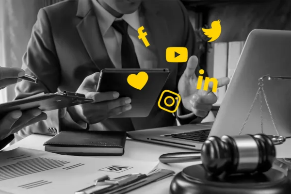 Social Media Best Practices for Attorneys, shows attorney at computer using social media marketing