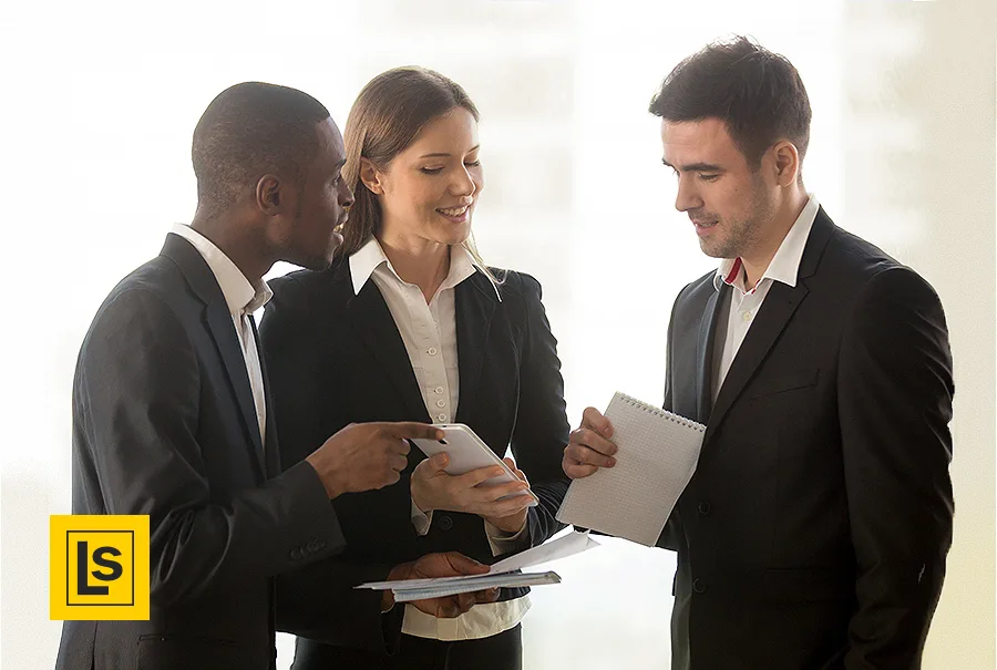 Three attorneys stand chatting