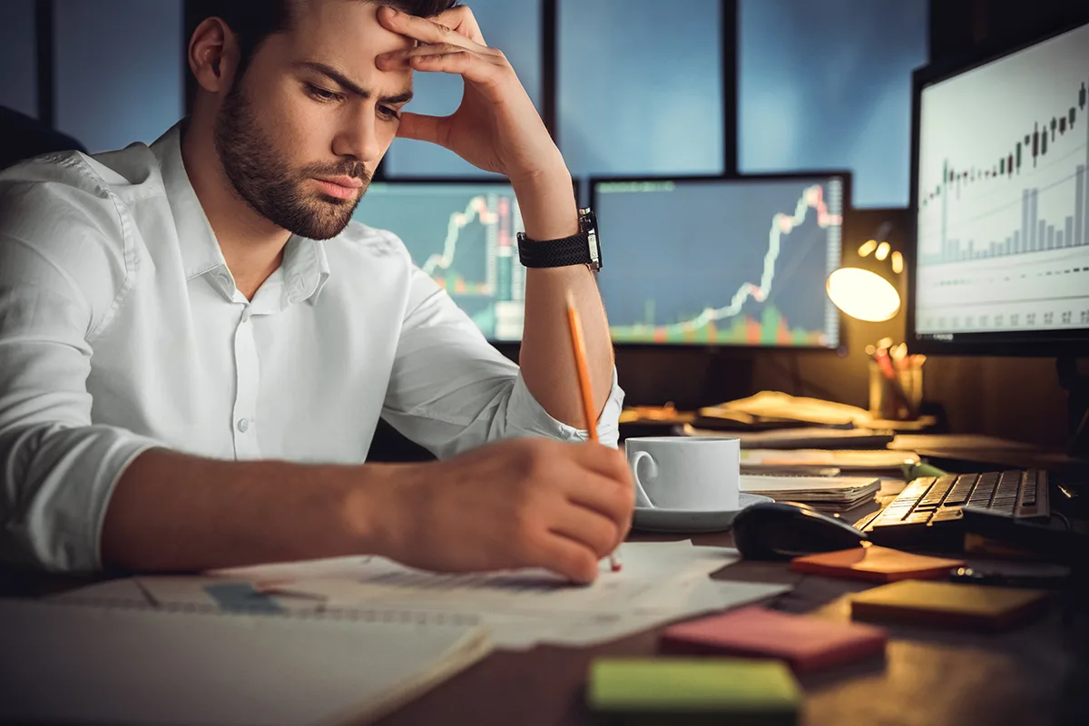 Business owner at a cluttered desk labors over a digital marketing strategy