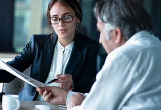 An attorney meets with a legal client to go over court documents