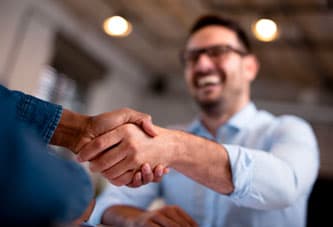 A new client and local business owner shake hands, representing the power of lead generation tools