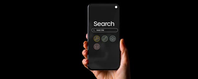 A client holds up a smartphone open to a Search Engine SEO