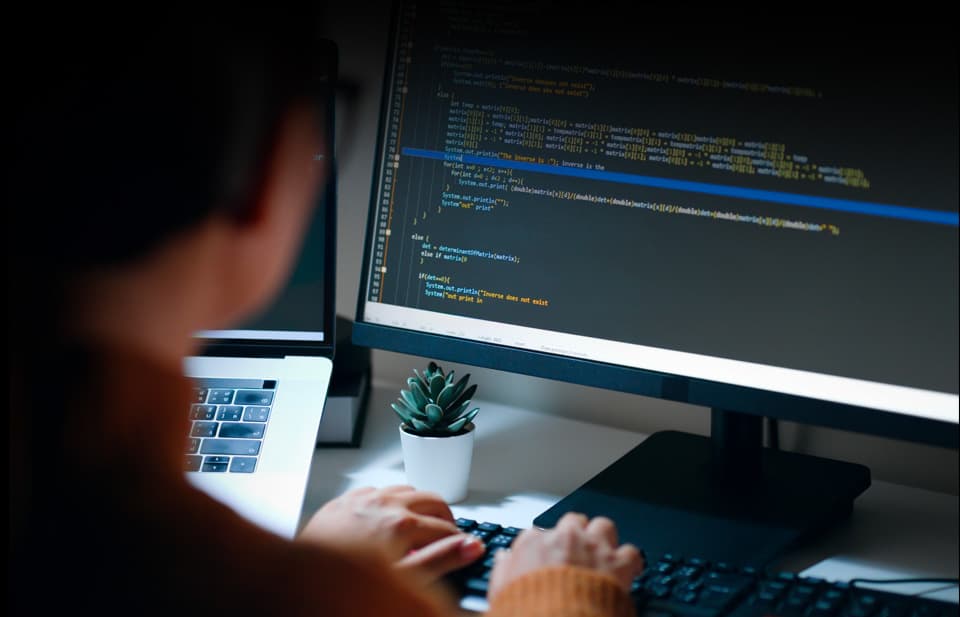 A Lead Science team member types code into a computer while building a custom website and marketing platform for one of our law firm clients