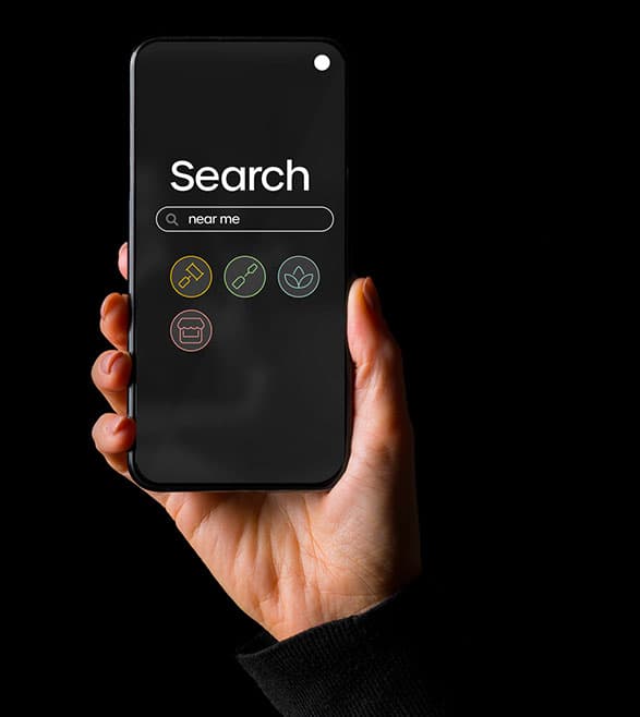 An upheld smartphone shows a search engine screen with 