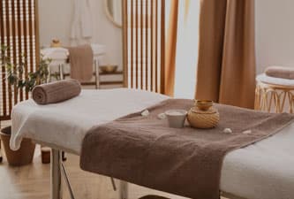 A MedSpa massage bed covered in flower petals